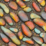 Multi-colored-river-rocks-with-water-flowing-around-them